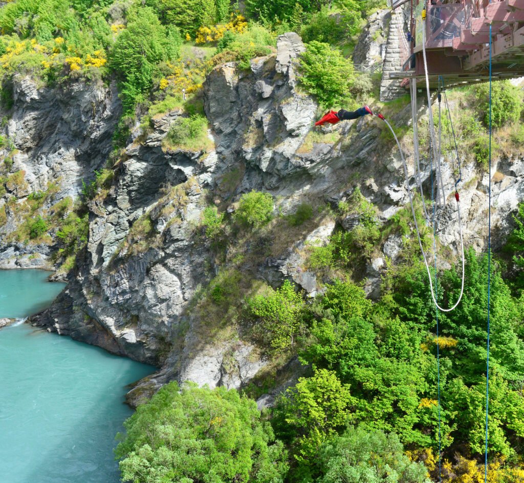 A daring bungee jumper mid-air at Kawarau Bridg